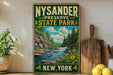 A vintage-style sign for the Nysander Preserve State Park in New York, featuring a scenic landscape with a waterfall and pine trees.