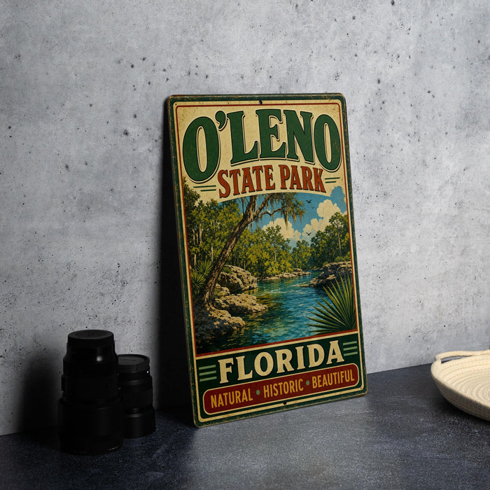 A vintage-style metal sign for O'Leno State Park in Florida, featuring a scenic landscape with a river and palm trees.