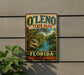 A vintage-style sign for O'Leno State Park in Florida, featuring a scenic landscape with palm trees and a river.
