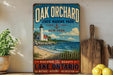 A vintage-style sign for Oak Orchard State Marine Park in New York, featuring a lighthouse and a beach scene.