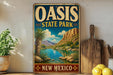 A vintage-style metal sign for Oasis State Park in New Mexico, featuring a scenic landscape with mountains, a river, and palm trees.