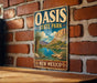 A vintage-style metal sign for Oasis State Park in New Mexico, featuring a scenic landscape with mountains, a lake, and palm trees.