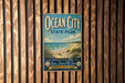 A vintage-style sign for Ocean City State Park, featuring a beach scene with a seagull and the text "Ocean City State Park" prominently displayed.