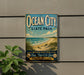 a vintage-style sign for Ocean City State Park, with a beach scene and birds in the background.