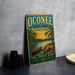 A vintage-style metal sign for Oconee State Park in South Carolina, featuring a scenic illustration of a lake, trees, and a canoe.