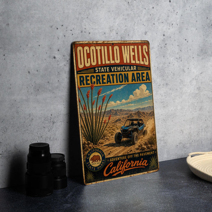 A vintage-style metal sign for the Ocotillo Wells State Vehicular Recreation Area, featuring an illustration of a blue off-road vehicle and desert landscape.