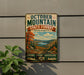 A vintage metal sign advertising October Mountain State Forest in Massachusetts, featuring a scenic landscape with mountains, trees, and a lake.