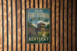 A vintage-style metal sign for Old Fort Harrod State Park in Kentucky, featuring a wooden fence and a tower, mounted on a wooden wall.