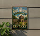 A vintage-style sign for Old Fort Harrod State Park in Kentucky, featuring a wooden fort and a path leading to the entrance.