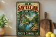 a vintage-style sign for Old Santee Canal State Park in South Carolina, with a scenic illustration of a canal, trees, and a bird.