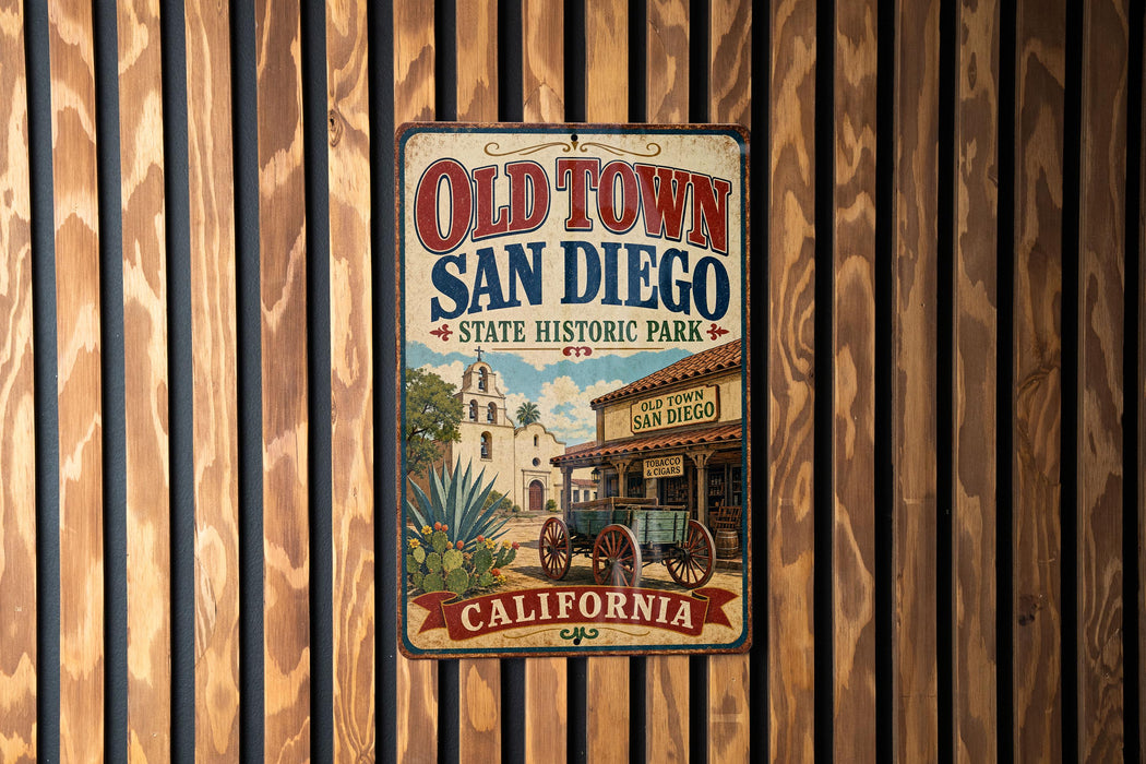 A vintage-style metal sign for Old Town San Diego, California, featuring a historical building and a wagon, is displayed on a wooden wall.
