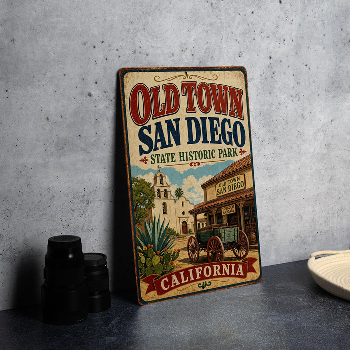 A vintage-style metal sign for Old Town San Diego, featuring an illustration of a historical building and a wagon, with the text "Old Town San Diego State Historic Park" and "California" at the bottom.