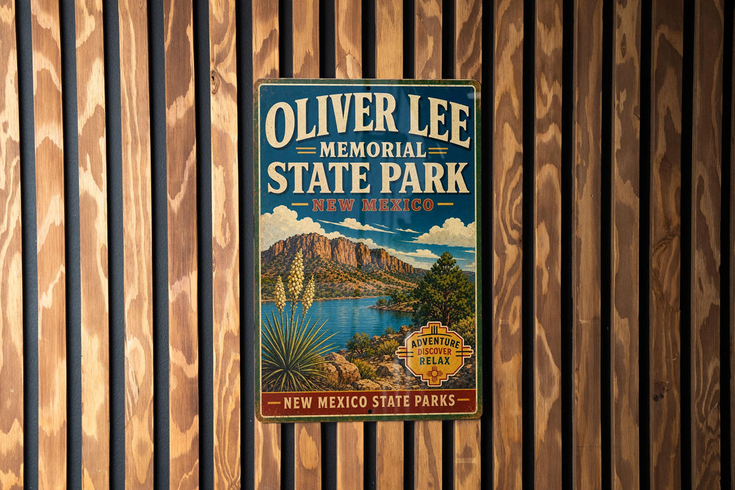 A vintage-style metal sign for Oliver Lee Memorial State Park in New Mexico, featuring a scenic landscape with mountains, a lake, and desert vegetation.