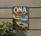 A vintage-style sign for Onda Beach State Park in Oregon, featuring a scenic beach landscape with mountains in the background.
