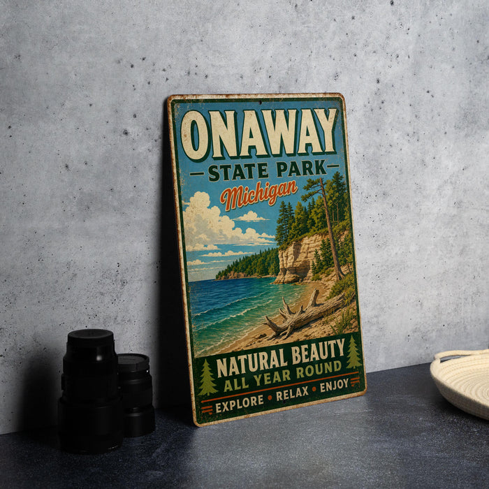 A vintage-style sign for Onaway State Park in Michigan, featuring a scenic landscape with a beach, cliffs, and pine trees.