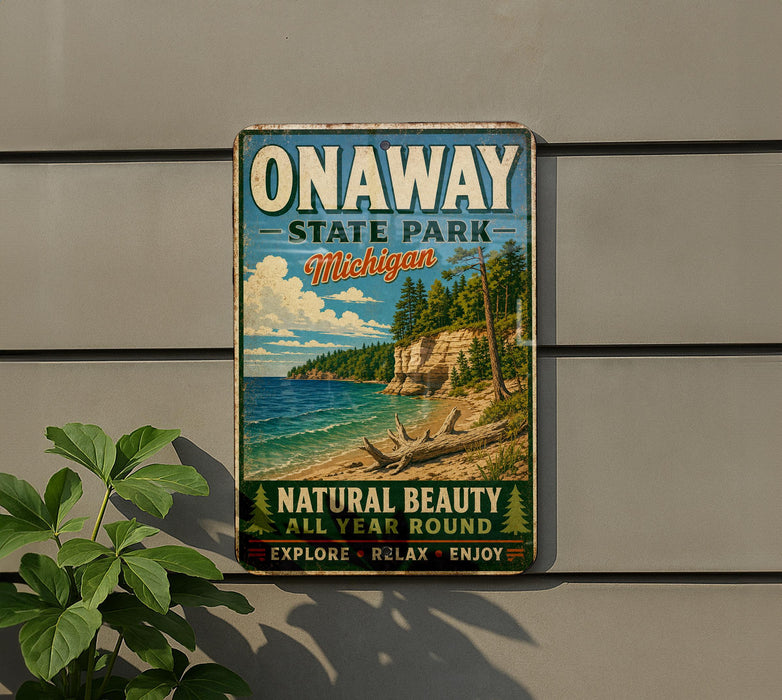 A vintage-style sign for Onaway State Park in Michigan, featuring a scenic beach landscape with a cliff and pine trees.
