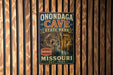 A vintage-style metal sign for Onondaga Cave State Park in Missouri, featuring an illustration of the cave and the text "Missouri" and "Est. 1926".