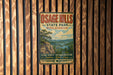 A vintage-style metal sign for Osage Hills State Park in Oklahoma, featuring a scenic landscape with a river and mountains.