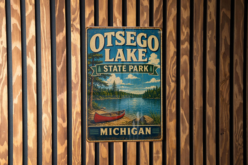A vintage metal sign for Otsego Lake State Park in Michigan, featuring a scenic illustration of a lake, canoe, and forest.