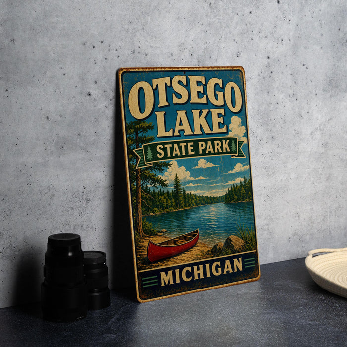 A vintage-style metal sign for Otsego Lake State Park in Michigan, featuring a scenic illustration of a lake, canoe, and surrounding landscape.