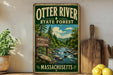 A vintage-style metal sign for Otter River State Forest in Massachusetts, featuring a scenic image of a river surrounded by pine trees and mountains.