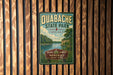 A vintage-style metal sign for Quabache State Park, Indiana, featuring a scenic landscape with a river and trees.