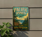 A vintage-style metal sign for Pacific Pines State Park in Washington, featuring a scenic landscape with pine trees, mountains, and a body of water.