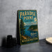 A vintage-style metal sign for Paradise Point State Park in Washington, featuring a scenic landscape with a mountain, pine trees, and a lake.