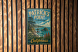 A vintage-style metal sign for Patrick's Point State Park in California, featuring a scenic landscape with mountains, trees, and a body of water.