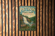 A vintage metal sign for Pattison State Park in Wisconsin, featuring a waterfall and forest scenery.