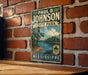 A vintage metal sign for Paul B. Johnson State Park in Mississippi, featuring a scenic landscape with a lake and trees.