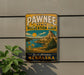 A vintage metal sign for the Pawnee State Recreation Area in Nebraska, featuring a scenic landscape with mountains, a river, and sunflowers.