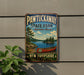 A vintage metal sign for Pawtuckaway State Park, featuring a canoe and a scenic landscape, is displayed on a wall.