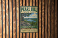 A vintage metal sign for Pearl Hill State Park in Massachusetts, featuring a scenic landscape with a lake and mountains.
