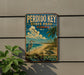 A vintage-style sign for Perdido Key State Park, Florida, featuring a beach scene with a heron, palm trees, and a bird.