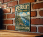 A vintage-style metal sign for Perrot State Park in Wisconsin, featuring a scenic illustration of a lake and mountains.