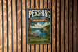 A vintage metal sign for Pershing State Park in Missouri, featuring a scenic landscape with a river, mountains, and a small boat.