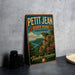 A vintage-style poster advertising Petit Jean State Park in Arkansas, featuring a scenic landscape with a cliff and a river.