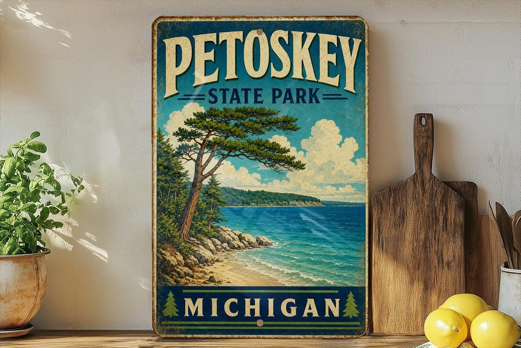 A vintage-style sign for Petoskey State Park in Michigan, featuring a scenic landscape with a pine tree, beach, and ocean.
