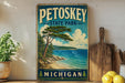 A vintage-style sign for Petoskey State Park in Michigan, featuring a scenic landscape with a pine tree, beach, and ocean.