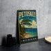 A vintage-style metal sign for Petoskey State Park in Michigan, featuring a scenic landscape with a pine tree and a body of water.