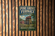 A vintage-style metal sign for Pine Grove Furnace State Park in Pennsylvania, featuring an illustration of a red brick building with a tower.