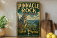 A vintage-style sign for Pinnacle Rock State Park in West Virginia, featuring a scenic mountain landscape with a river and pine trees.