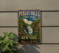 A vintage-style metal sign for Pixley Falls State Park, featuring a waterfall and lush greenery, is displayed on a gray wall.