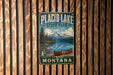 A vintage metal sign for Placid Lake State Park in Montana, featuring a scenic landscape with a lake, mountains, and a canoe.