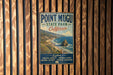 A vintage metal sign for Point Mugu State Park, California, featuring a coastal landscape with rugged cliffs and a rocky outcrop.
