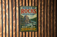 A vintage metal sign for Point of Rocks State Park in Maryland, featuring a scenic illustration of a mountain and river.