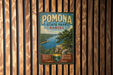 A vintage-style metal sign for Pomona State Park, Kansas, featuring a scenic landscape with a lake and mountains.