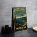 A vintage-style metal sign for Porcupine Mountains Wilderness State Park in Michigan, featuring a scenic landscape with mountains, trees, and a lake.