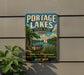 A vintage-style metal sign for Portage Lakes State Park in Ohio, featuring a scenic illustration of a lake, park benches, and a sailboat.